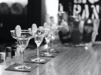 grayscale photography of margarita glass on table